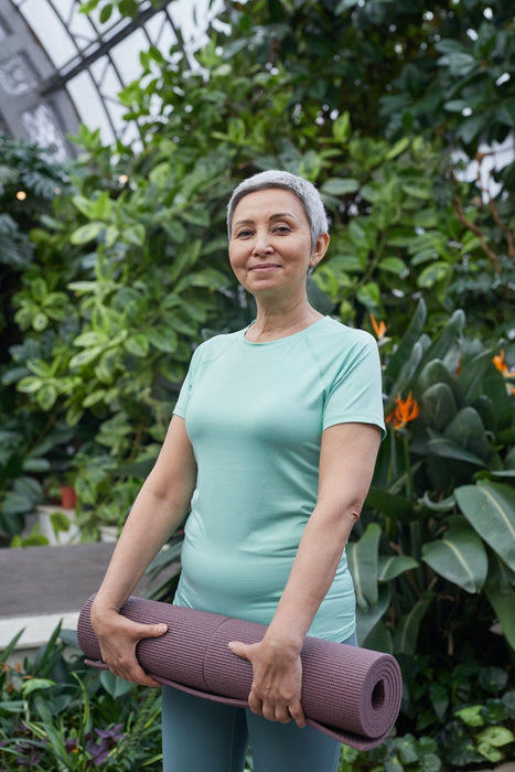Woman getting ready for yoga to help maintain health and wellness during menopause